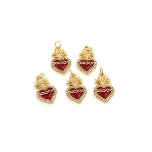 Macro detail of five 18K gold plated heart pendants with red enamel and zircon accents