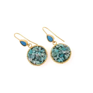 Detail of 18K gold plated earrings featuring blue stones and natural mineral chips