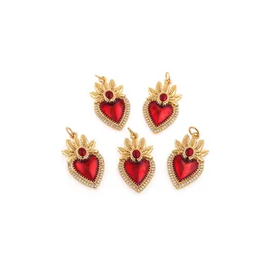 Gros plan de pendentifs cœur plaqués or 18 carats avec cristaux rouges et zircons