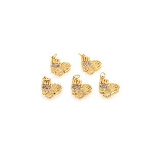 Close-up of five 18K gold plated hand-shaped pendants with sparkling zircon stones