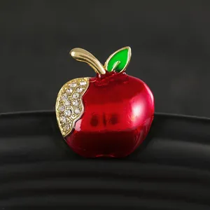 Sparkling red apple brooch with gold stem, green leaf, and inlaid white rhinestones