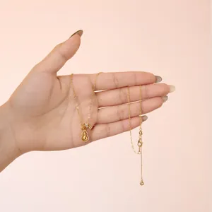 Macro shot of gold S925 gourd pendant with white zircon and lobster clasp chain