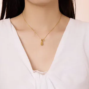 Close-up of a gold s925 gourd pendant necklace with white zircon pavé on a female neck