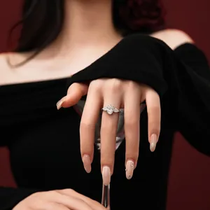 Three-stone ring featuring oval-cut moissanite and pear-shaped side stones on a model