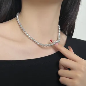 Close-up of a high-polish S925 silver beaded necklace worn on a woman's collarbone