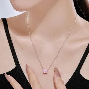 Close-up of radiant pink square gemstone necklace worn on woman's collarbone