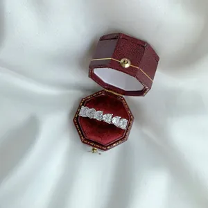 Close-up of S925 silver eternity ring with heart-cut zircons in a vintage red gift box