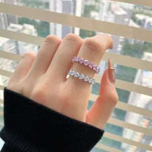 Close-up of sparkling S925 silver eternity rings featuring pink and clear heart zircon stones