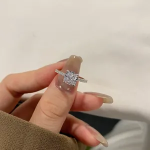 Macro shot of cushion cut square gemstone in four-prong pavé setting sterling silver ring