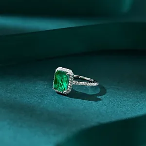 Green emerald cut zircon ring in S925 silver with halo diamonds on velvet background