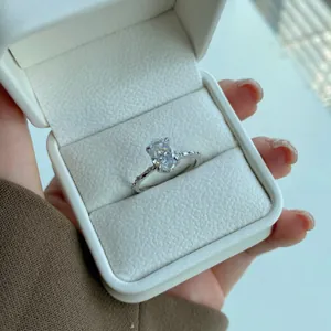 Close-up of S925 silver ring with oval cut diamond and micro-pave setting in white box