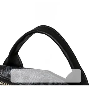 Detail shot of sturdy black pebble leather handles and grey checkered pattern backpack