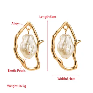 Irregular golden alloy earrings with baroque pearls in elegant minimalist style
