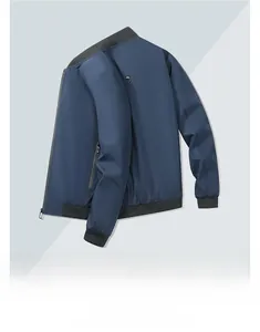 Detail of blue bomber jacket featuring ribbed collar and metallic back ornament