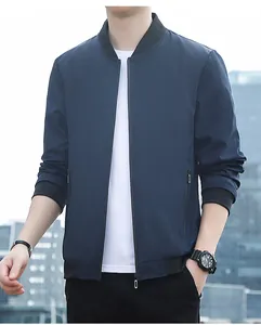 Close-up of ribbed cuffs and zip pockets on a navy blue men's slim bomber jacket