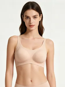 Close-up of nude seamless wire-free bra featuring wide straps and vertical ribbed hem