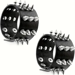 Detail of punk black leather bracelets with three rows of silver metal cone spikes