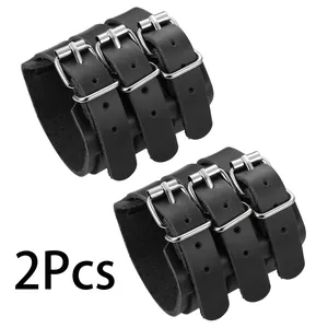 Detail of two black punk leather wristbands with three-row silver metal buckle fasteners