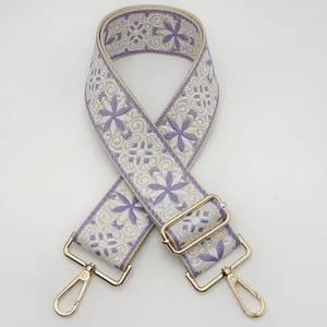 Ethnic style embroidered bag strap in purple and beige with golden lobster clasps