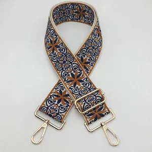 Ethnic style embroidered bag strap in dark blue and yellow with gold metal hardware
