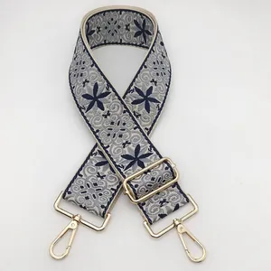 Ethnic embroidery bag strap in dark blue floral patterns with gold swivel hooks