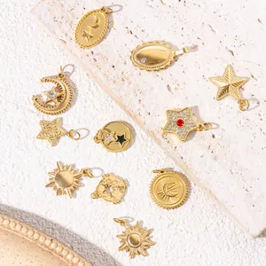 Detailed view of celestial gold charms with sun and moon motifs on a stone background
