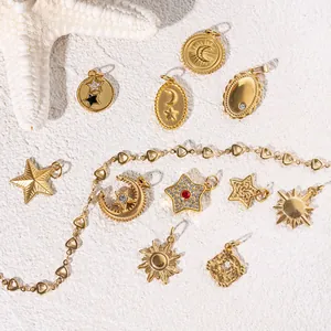 Golden celestial star and moon pendants on white sand with a heart link chain