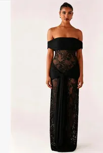 Detail of off-shoulder black lace patchwork dress with sheer floral texture and ties