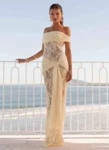 Detail of off-white lace off-shoulder dress with elegant draping ribbons and ruffles