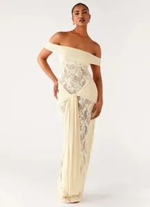 Elegant off-shoulder lace dress featuring draped ribbon detail in soft cream yellow