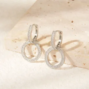 Close-up of elegant silver double hoop earrings with pave-set shimmering zircon stones