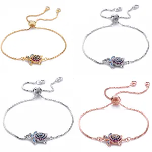 Macro detail of copper turtle bracelets featuring colorful zircon stones and slide clasp