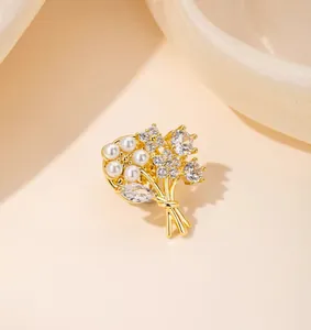 Macro shot of elegant floral brooch with white pearls and sparkling zircons on gold stem