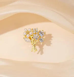 Detailed view of elegant flower bouquet brooch with white pearls and sparkling zircons