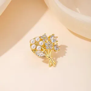 Elegant gold flower bouquet brooch with white pearls and sparkling crystal zircons