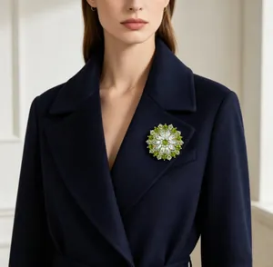 Detailed close-up of a green crystal sunflower brooch on a dark blue coat lapel