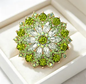 Detailed macro view of an elegant green crystal sunflower brooch with gold accents