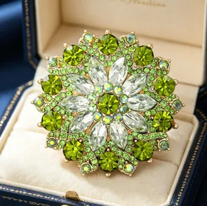 Macro shot of luxury green sunflower brooch with crystal petals in a premium gift box