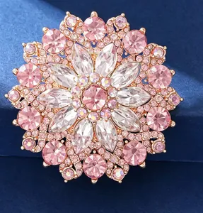 Close-up of pink crystal sunflower brooch in rose gold metal with sparkling rhinestones