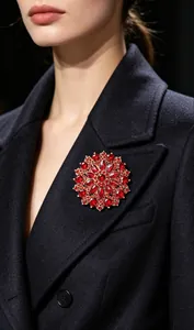 Detailed view of luxury red crystal sunflower brooch on a classic black wool coat lapel