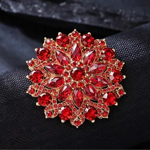 Elegant vintage sunflower brooch with deep red crystals and a gold-plated flower base