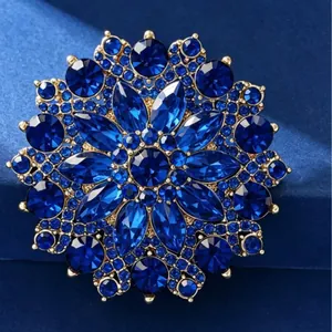 Elegant gold flower brooch with deep blue crystals and rhinestones for suits