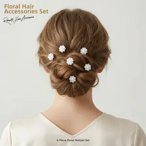 Set of 6 romantic white artificial flower U-shaped hairpins shown in a bun hairstyle