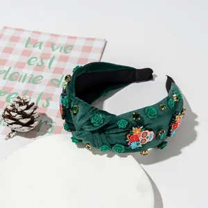 Green velvet headband with sugar skull, floral patterns and gemstone embellishments