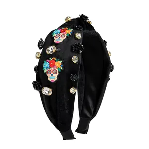 Close-up of Halloween headband featuring sugar skull embroidery and black velvet roses