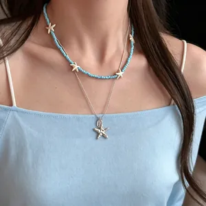 Double-layer blue beaded necklace with silver starfish pendants for a summer beach look