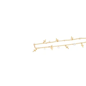 Detail of 18K gold plated chain with delicate cross charms and square zircon stones