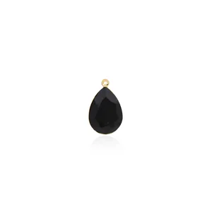 Detail of a pear-cut black zircon droplet pendant with 18K gold plated metal frame