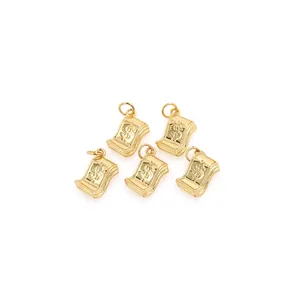 Detail of five 18K gold-plated dollar sign pendants for DIY jewelry making