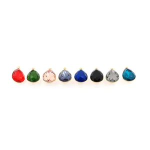 Detailed close-up of colorful 18K gold-plated teardrop pendants with faceted crystals